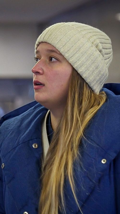 A woman with her groceries outside of a store