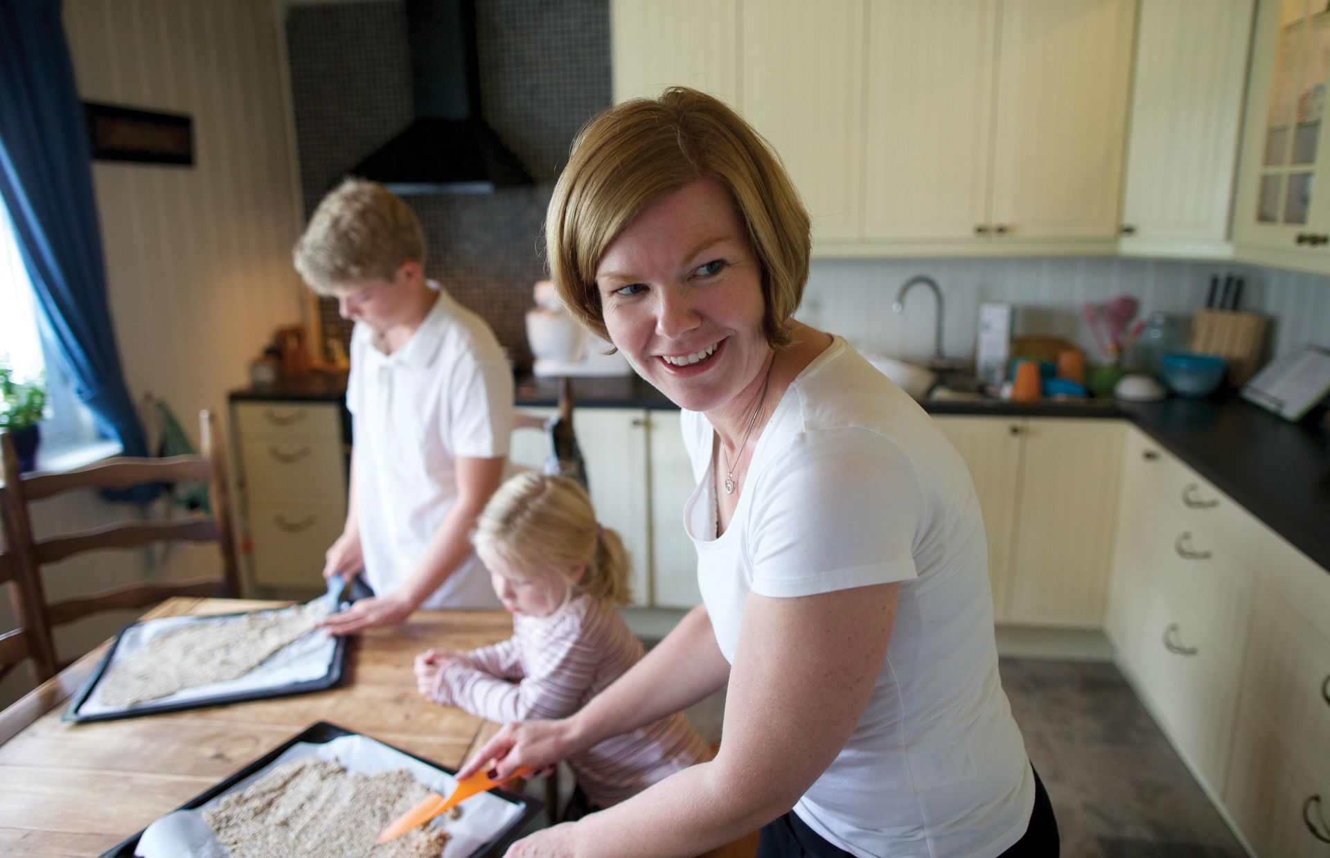 Elisabeth (right), Mia (center), and Mats (left) bake homemade crispbread.