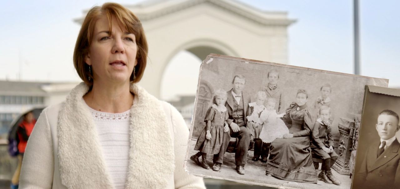 A woman with photographs of her ancestors