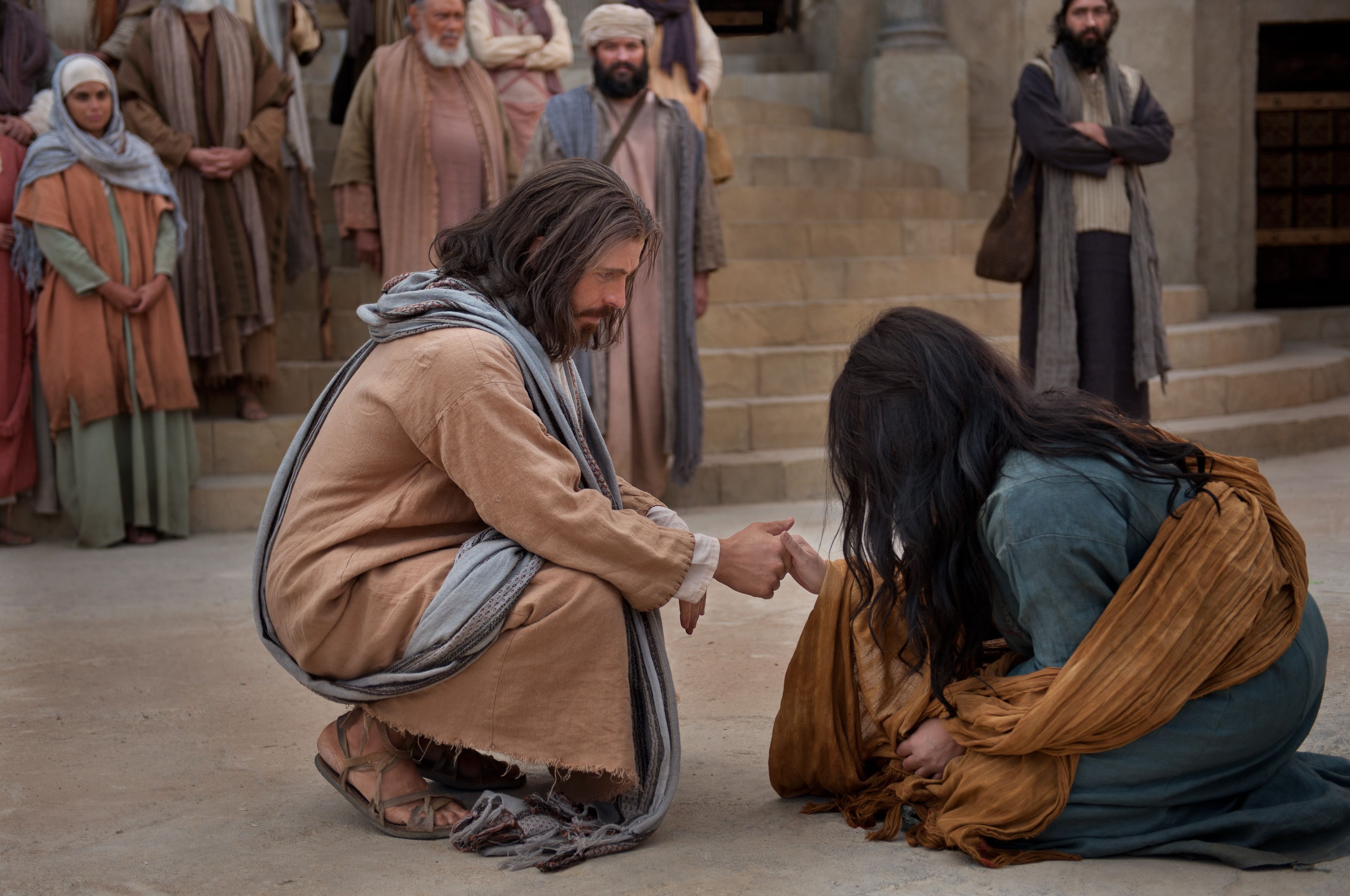 Jesus reaches out to help the woman taken in adultery.