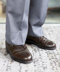 A senior missionary models appropriatesuits pants and shoes.