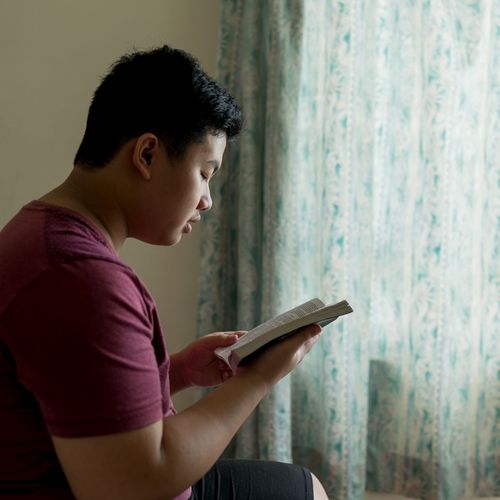 young man reading the scriptures