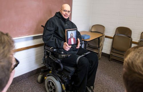 Ein Mann, der im Rollstuhl sitzt, unterrichtet in der Kirche