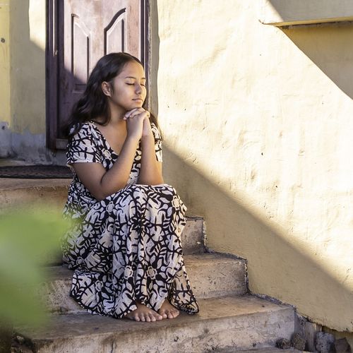 young woman sitting and pondering
