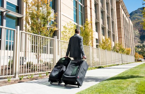 a young missionary carrying suitcases