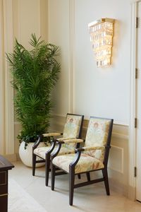 Photo of design details in the Yigo Guam Temple. Image shows a small sitting area with two chairs and a fake plant in the corner of the room.