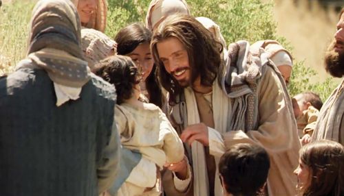 A photograph of Christ interacting with young children.