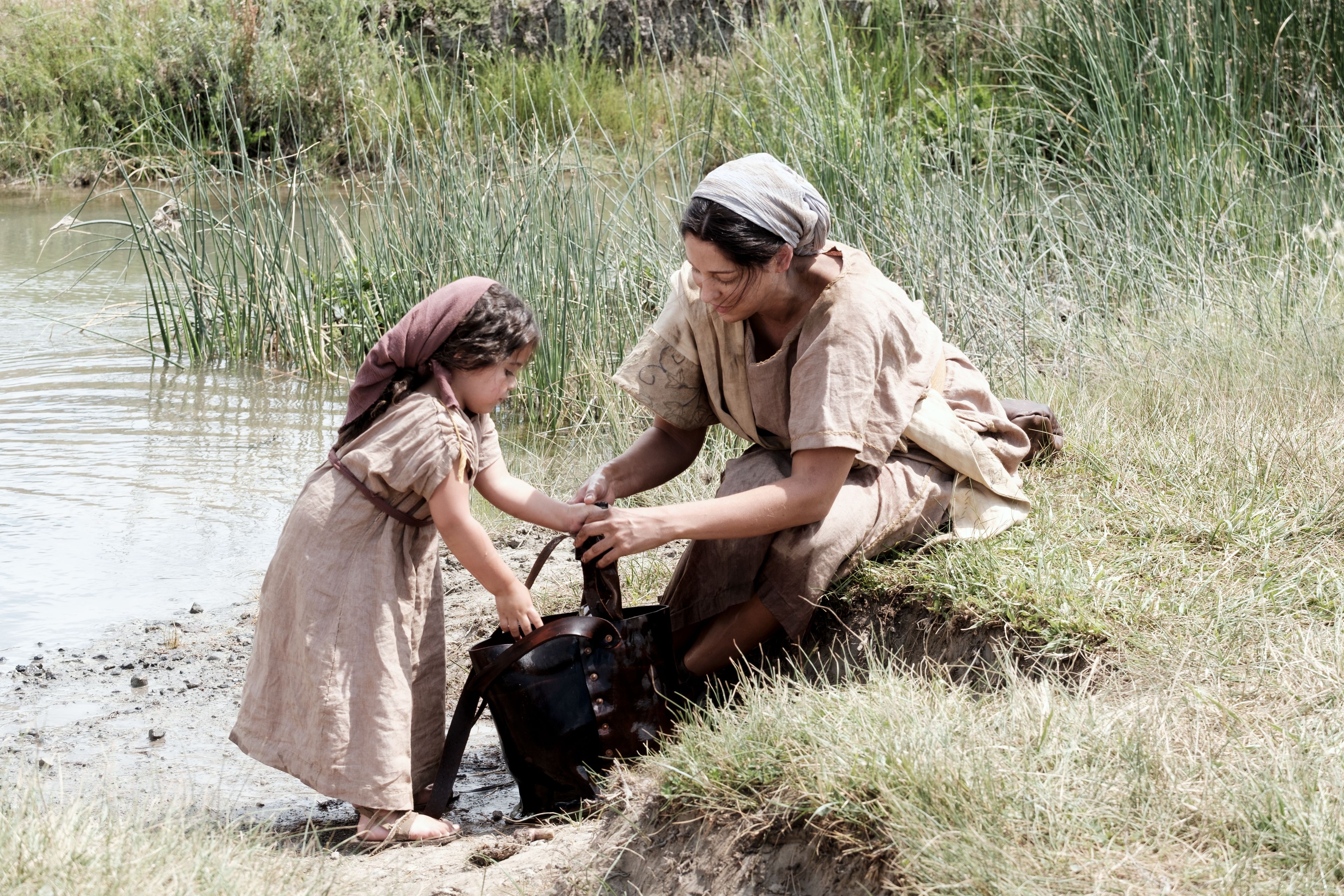 Daughter of Ishmael and child gathers water from a stream.