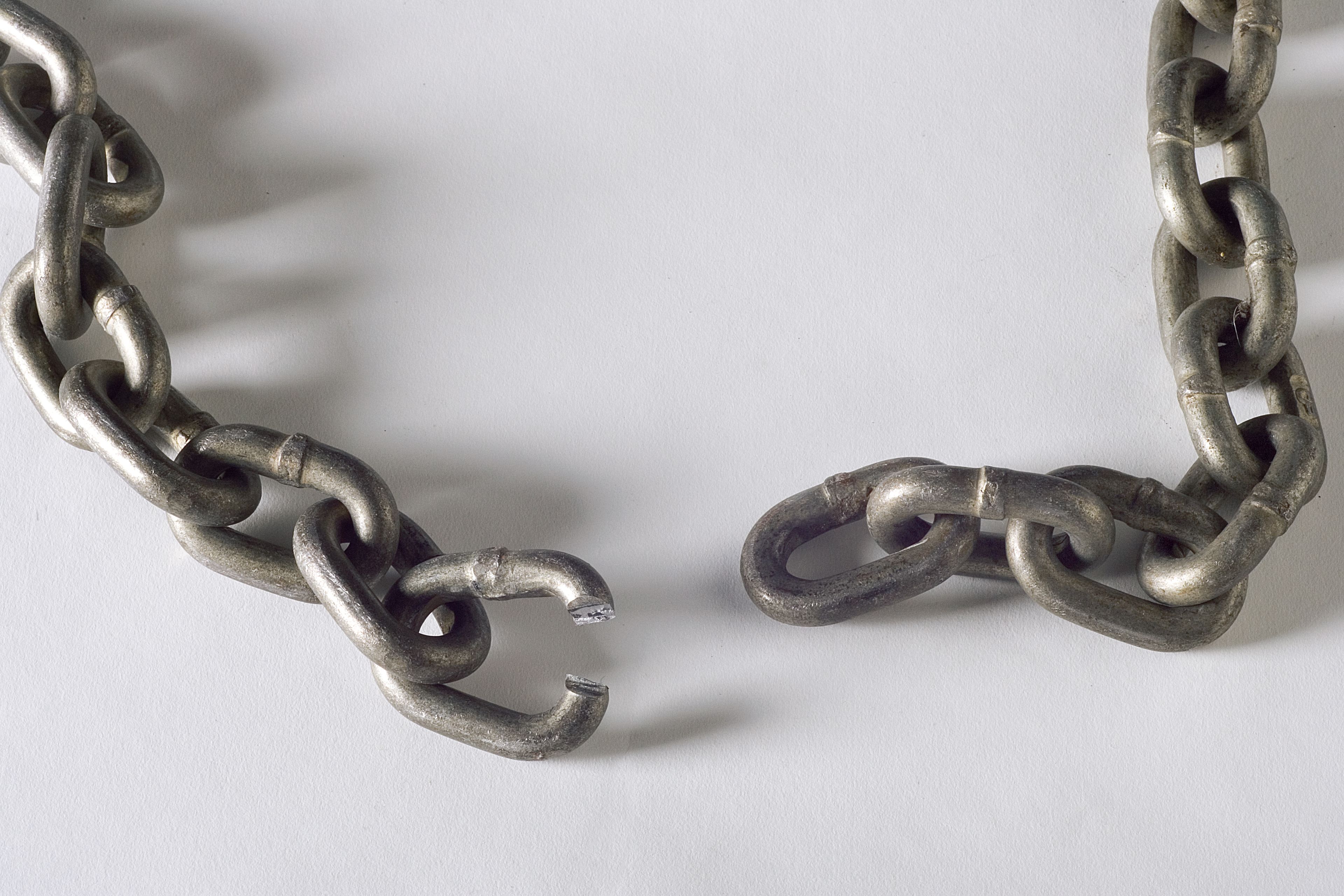 A heavy chain shown with a broken link.