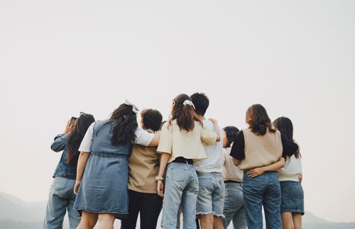 group of young adults looking at the sky