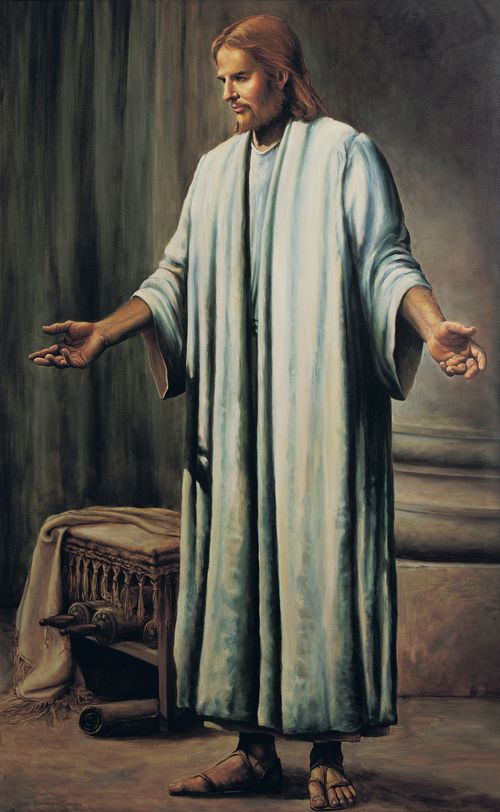 Christ in white robes and sandals, standing with outstretched arms in front of scrolls and a table seen in the background.