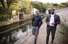 Cayo and Anthony walking alongside a waterway