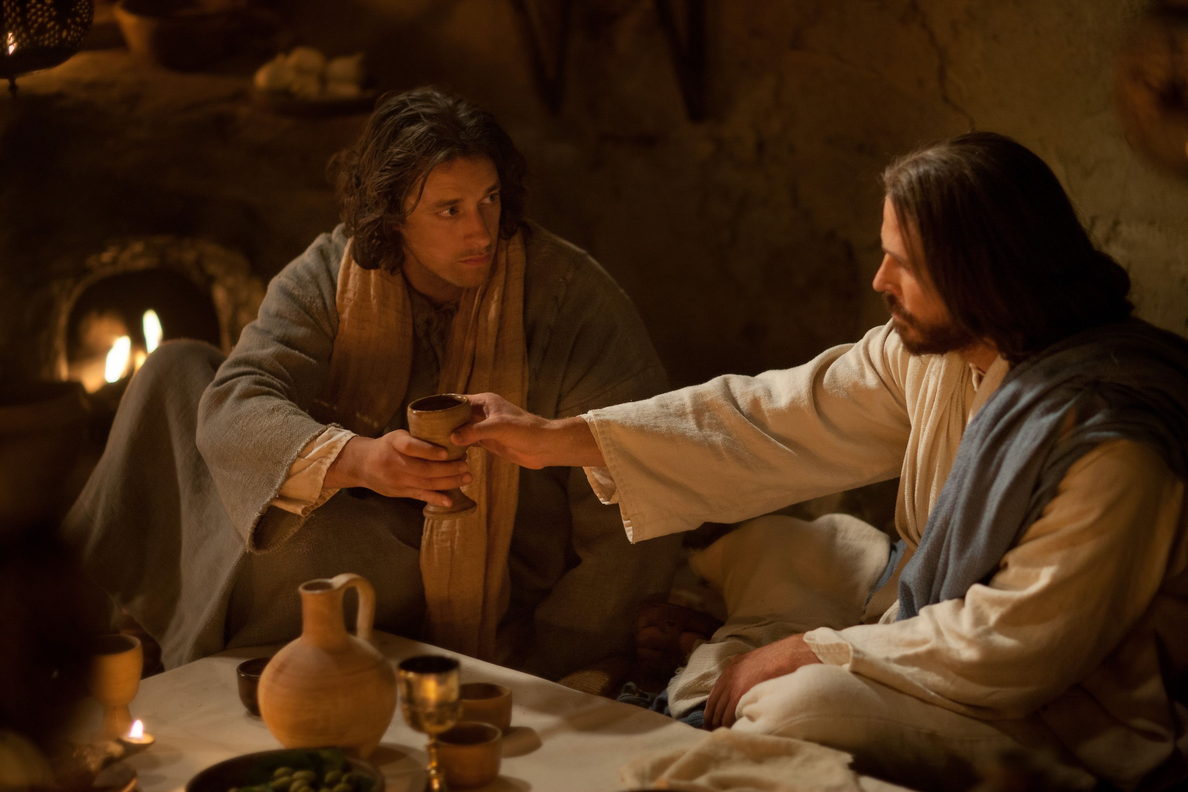 Jesus blesses and passes wine, which represents his blood, at the Last Supper with the Apostles.