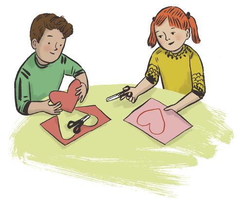 boy and girl cutting out paper hearts