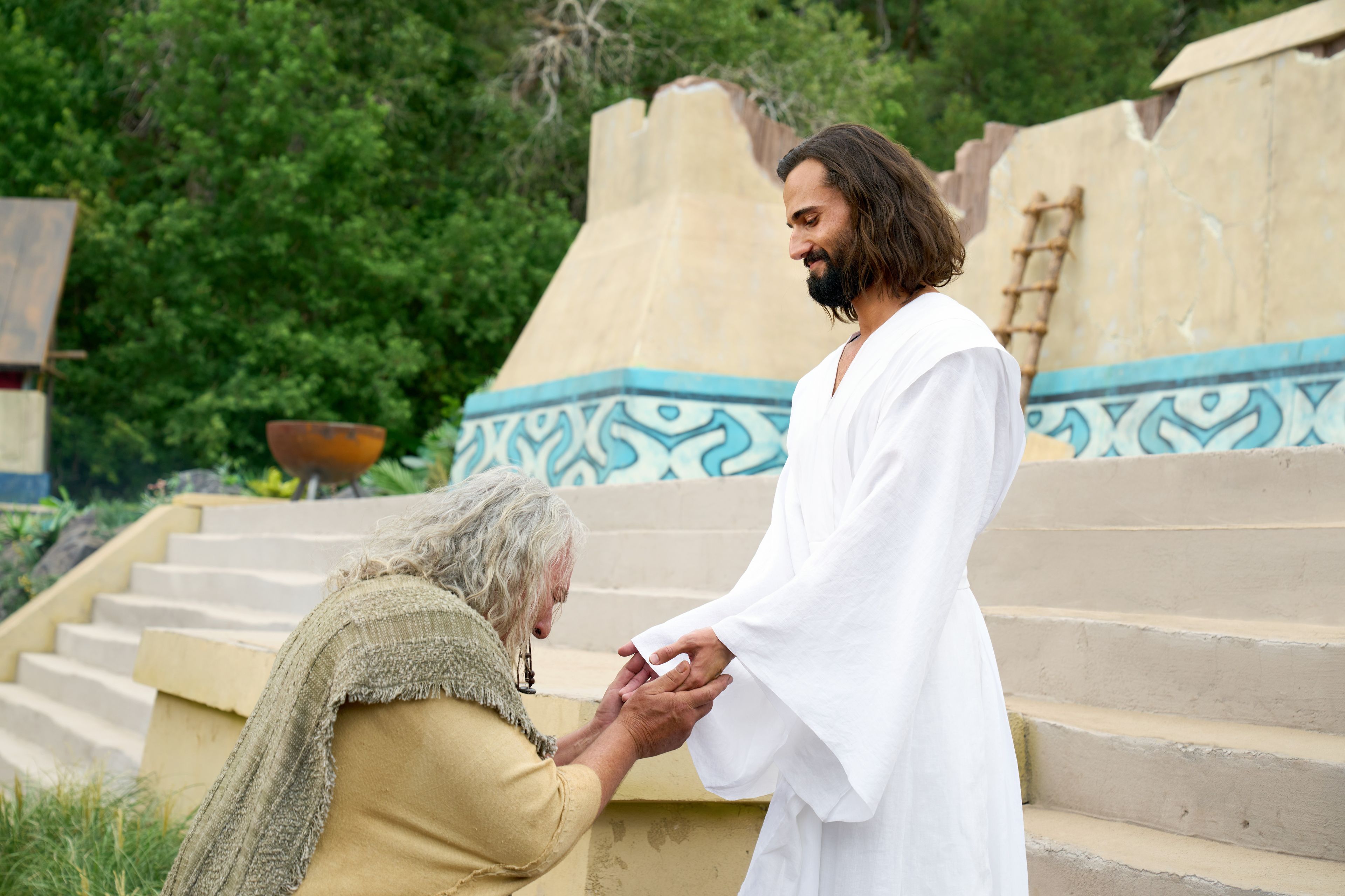 The resurrected Savior, Jesus Christ, appears to the ancient inhabitants of the Americas. Jesus holds out his hands and allows Nephi to touch them.
