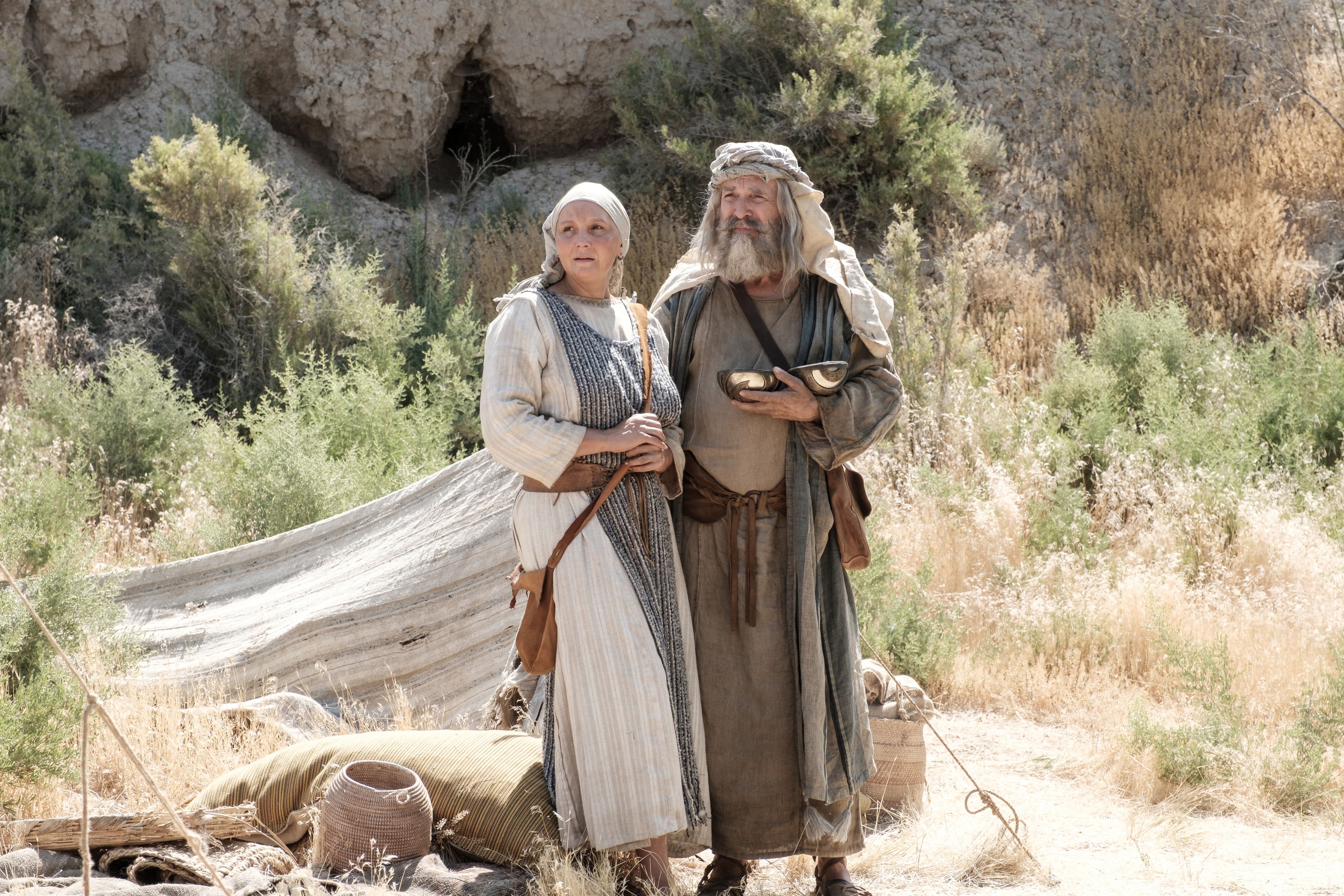 Lehi and Sariah use the Liahona in the wilderness.