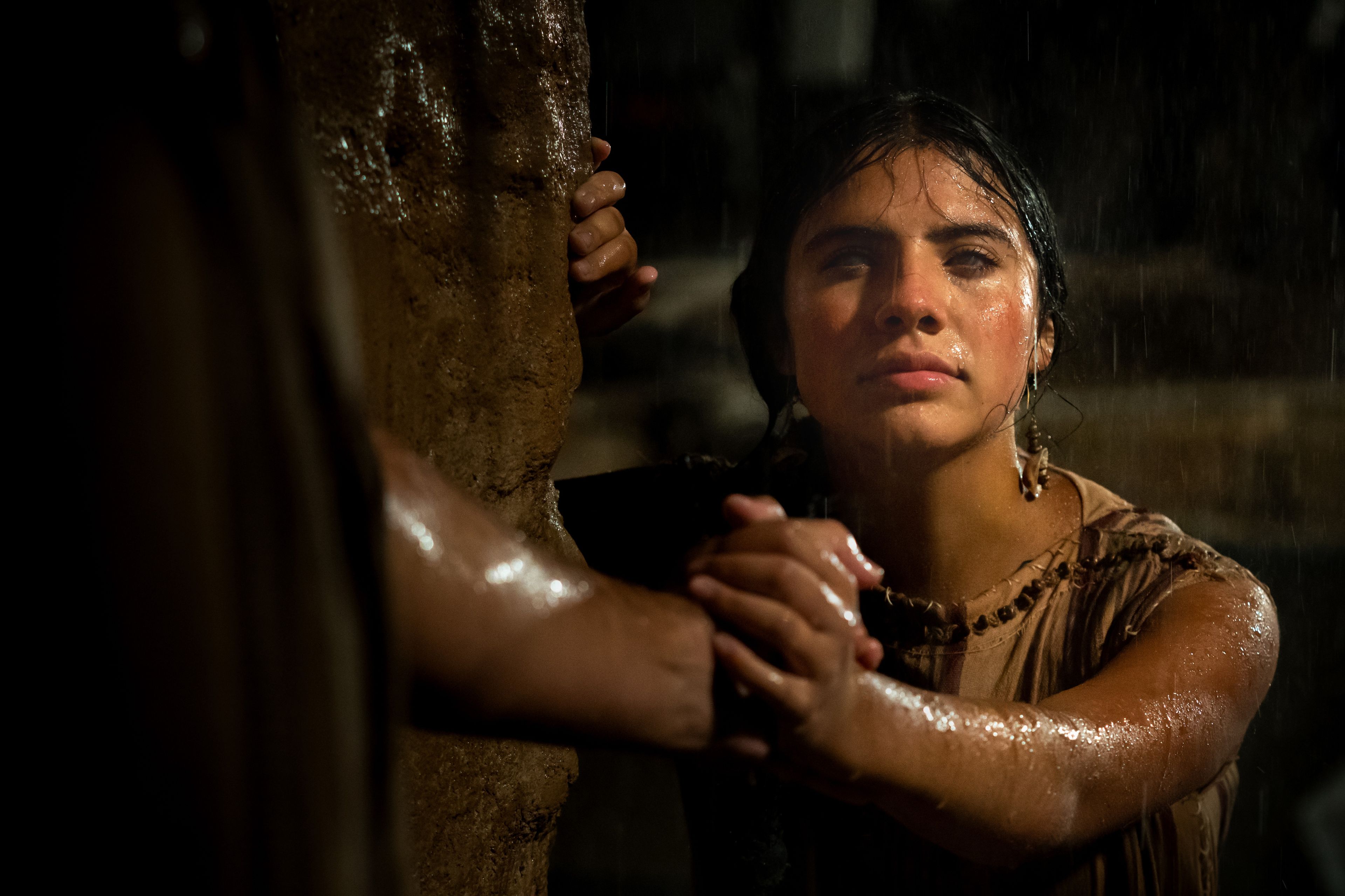 A flash flood sweeps people away, while a blind girl is rescued by her father.