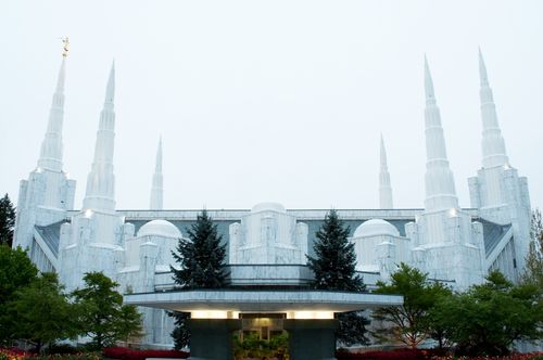 The entrance and side of the Portland Oregon Temple, with a gray sky overhead.