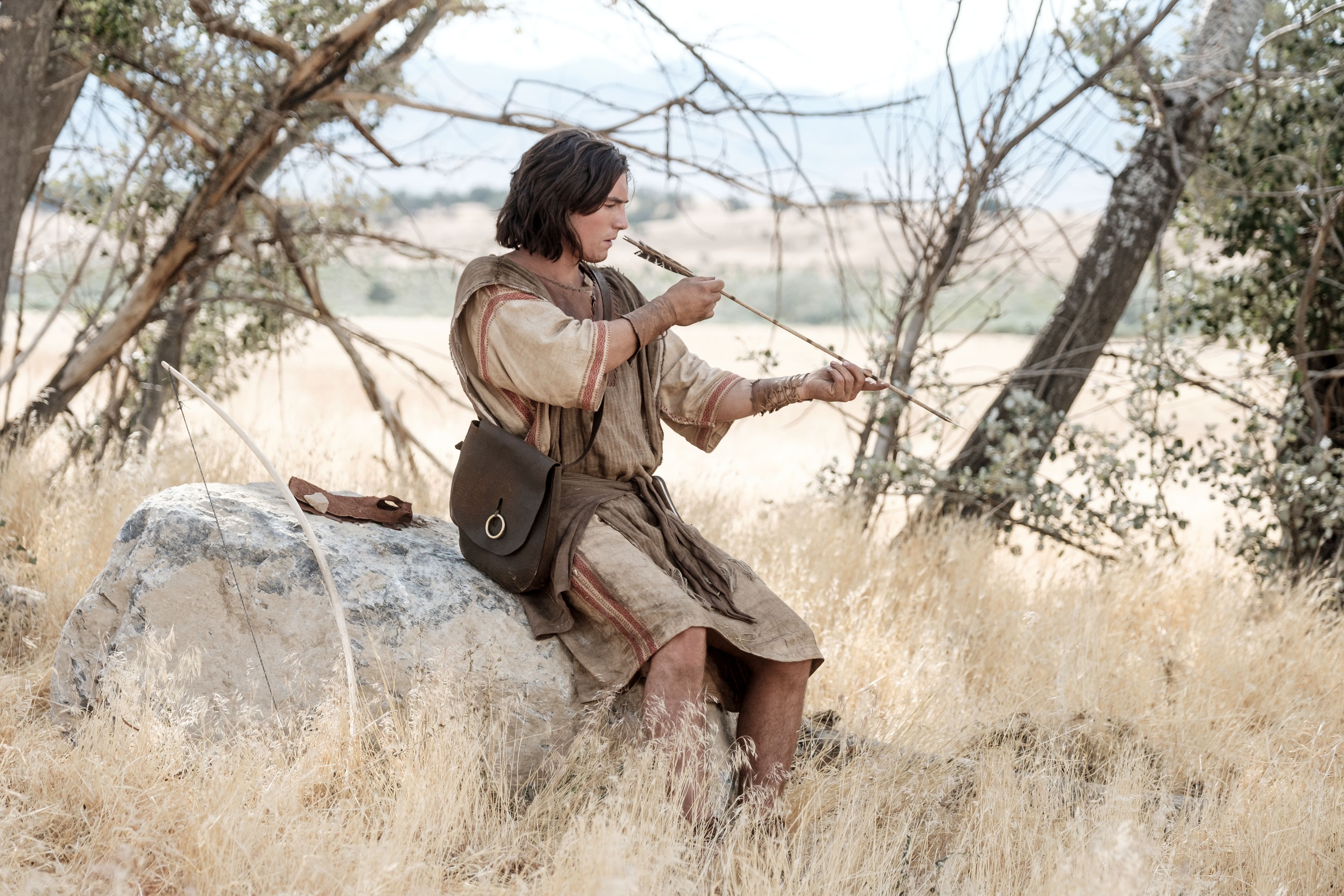 Nephi makes a bow and arrow in the wilderness.