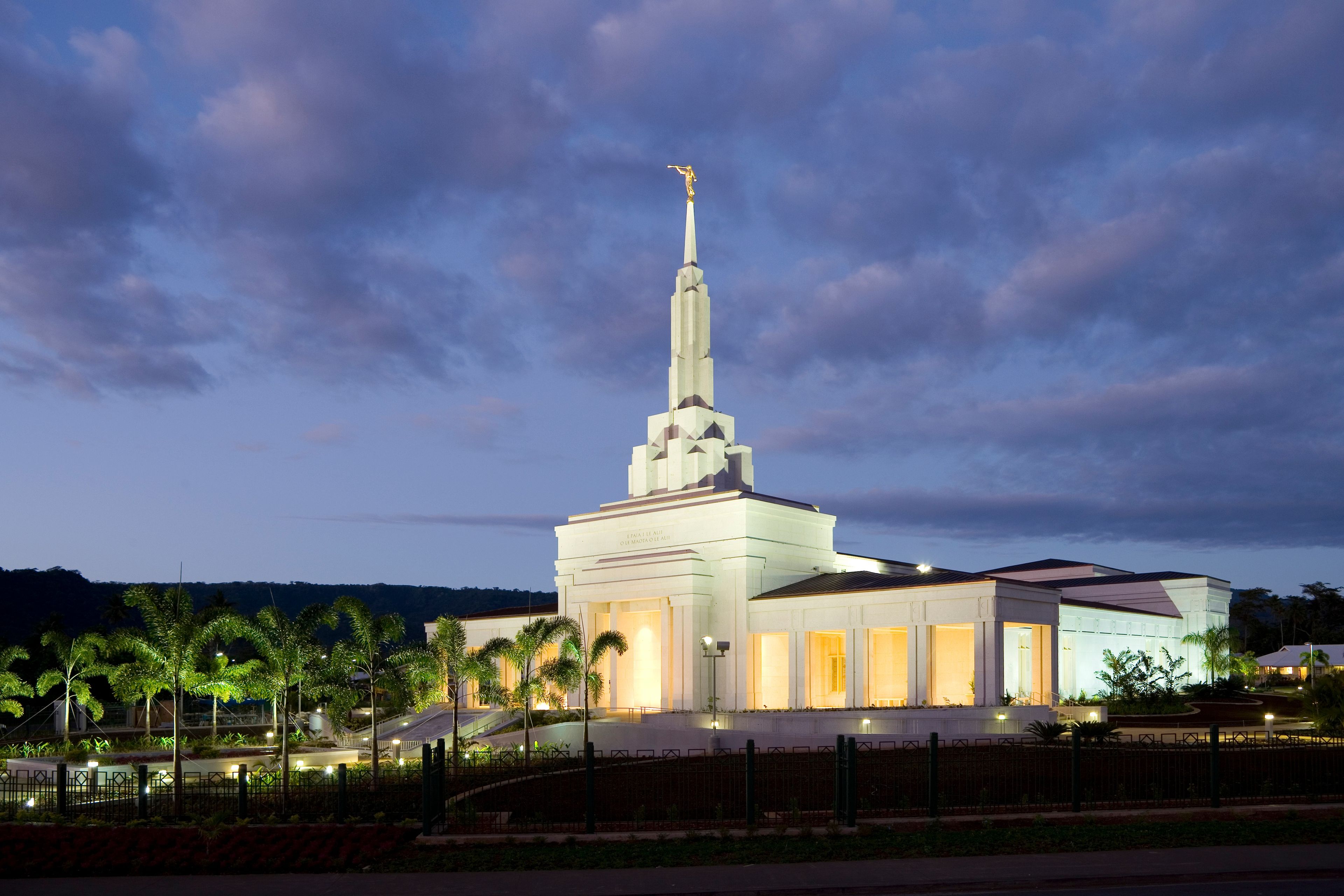 The Apia Samoa Temple lit up in the evening.