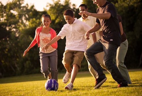 family playing soccer together