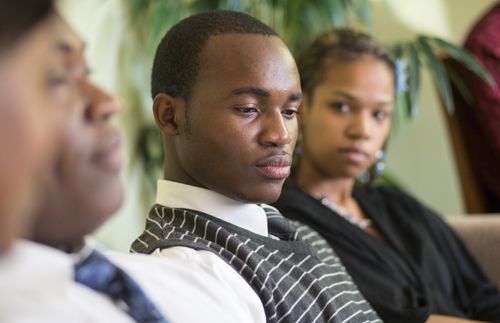 pensive young man with others