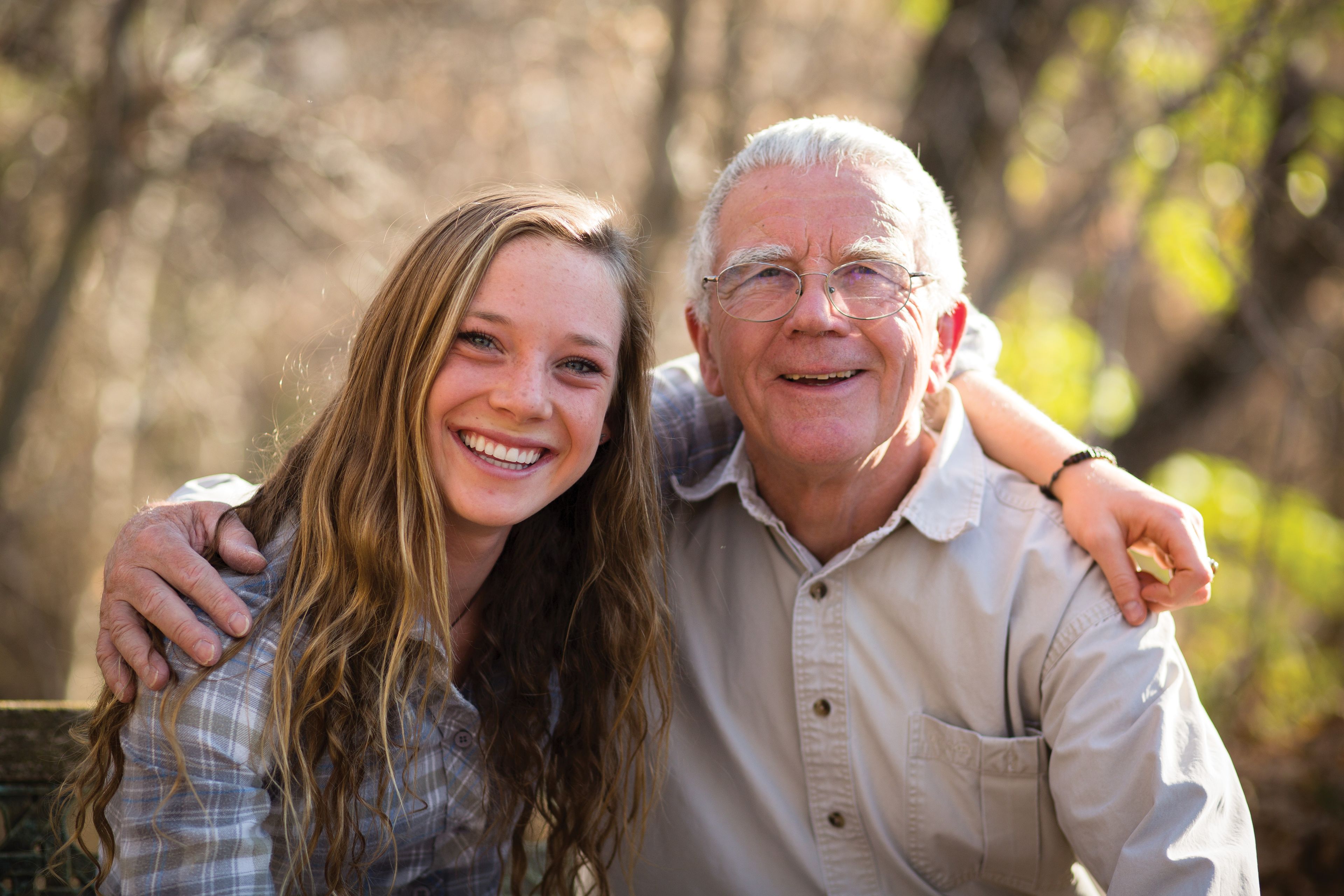 A man and his granddaughter, smiling.