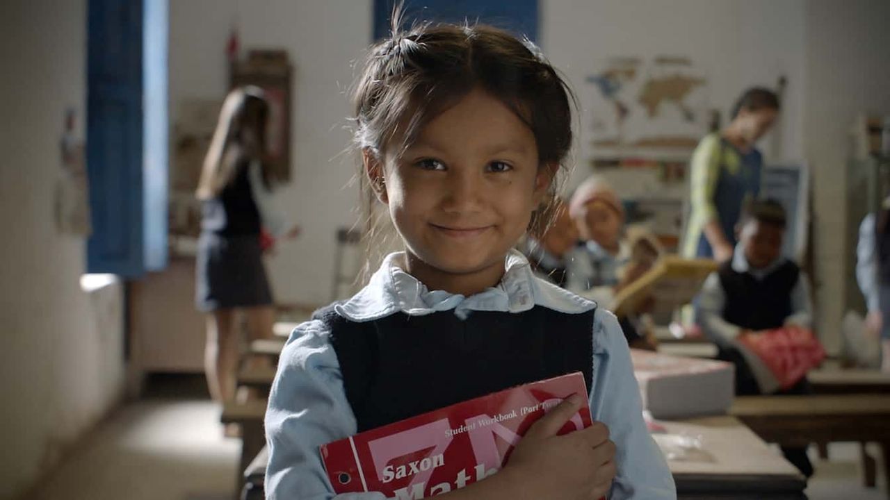 A girl holds donated school books