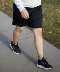 A sister missionaries is outside. She are modeling appropriate exercise clothing during  p-day. She is  jogging.