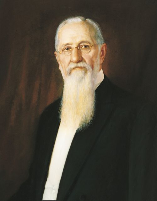 A portrait by A. Salzbrenner of Joseph F. Smith in a black suit, white shirt, and glasses.