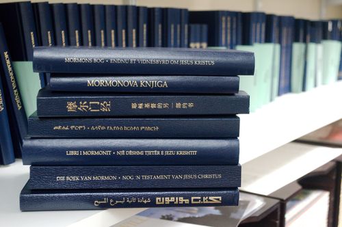A stack of copies of the Book of Mormon in many languages.
