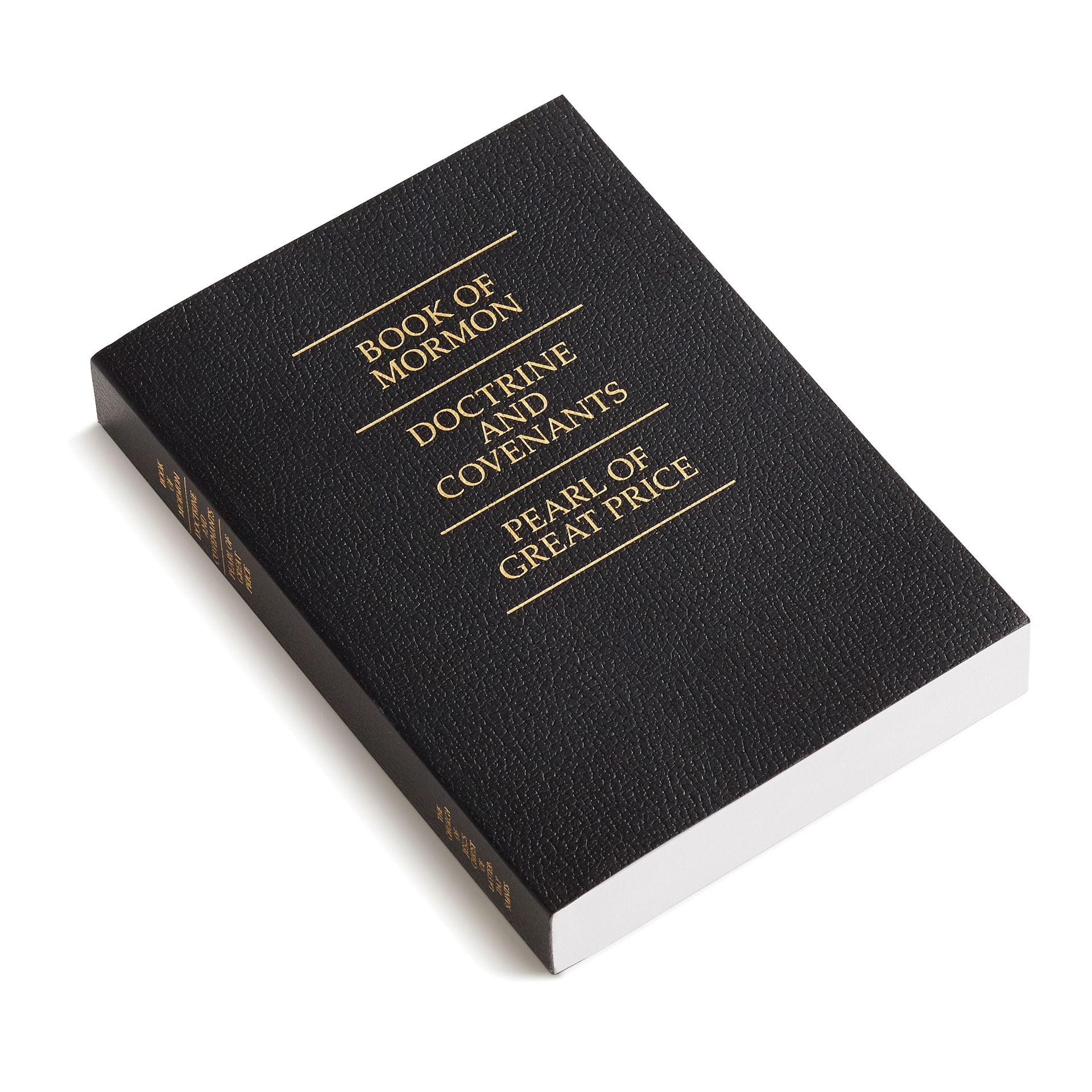 A softcover triple combination with gold text.