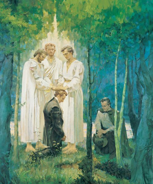 A painting by Kenneth Riley of Joseph Smith kneeling in a grove of trees and receiving the Melchizedek Priesthood through Peter, James, and John, with Oliver Cowdery nearby.