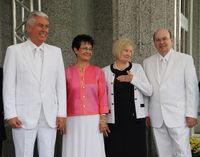 President Dieter F. Uchtdorf and Elder Quentin L. Cook stand with their wives during a temple dedication.