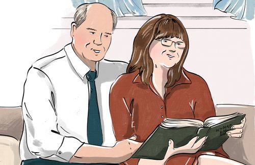 couple singing from hymbook together at home