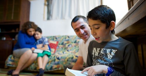 A family studies scriptures together in Armenia.