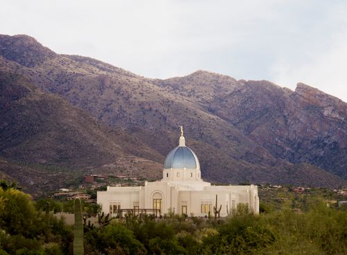 A photograph of the Tucson Arizona Temple framed by the mountains in the distance.
