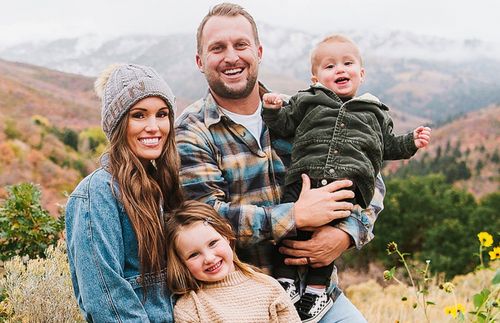 a wife and husband with their two small children