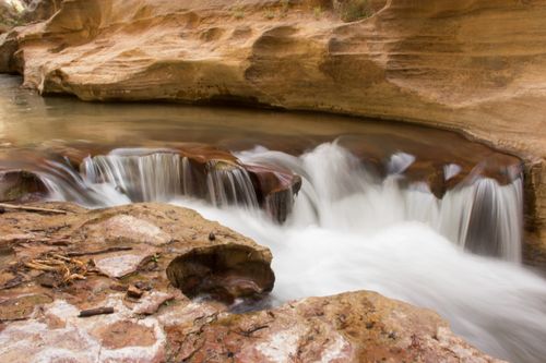 A river flowing over rocks in Zion National Park.