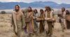 Jesus caminha com os discípulos carregando cestos de pães