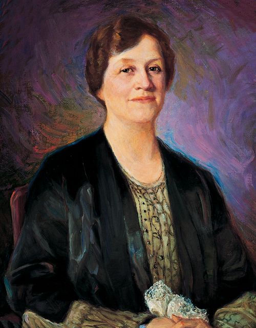 A painted portrait by John Willard Clawson of Louise Yates Robison against a purple background, wearing a green dress and a black jacket.