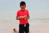 boy gathering shells