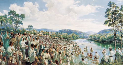 multitude of people on riverbank and being baptized in river