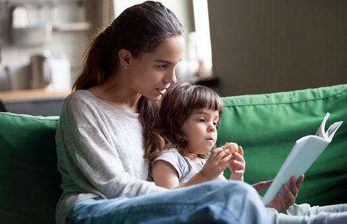 a woman and a child reading together