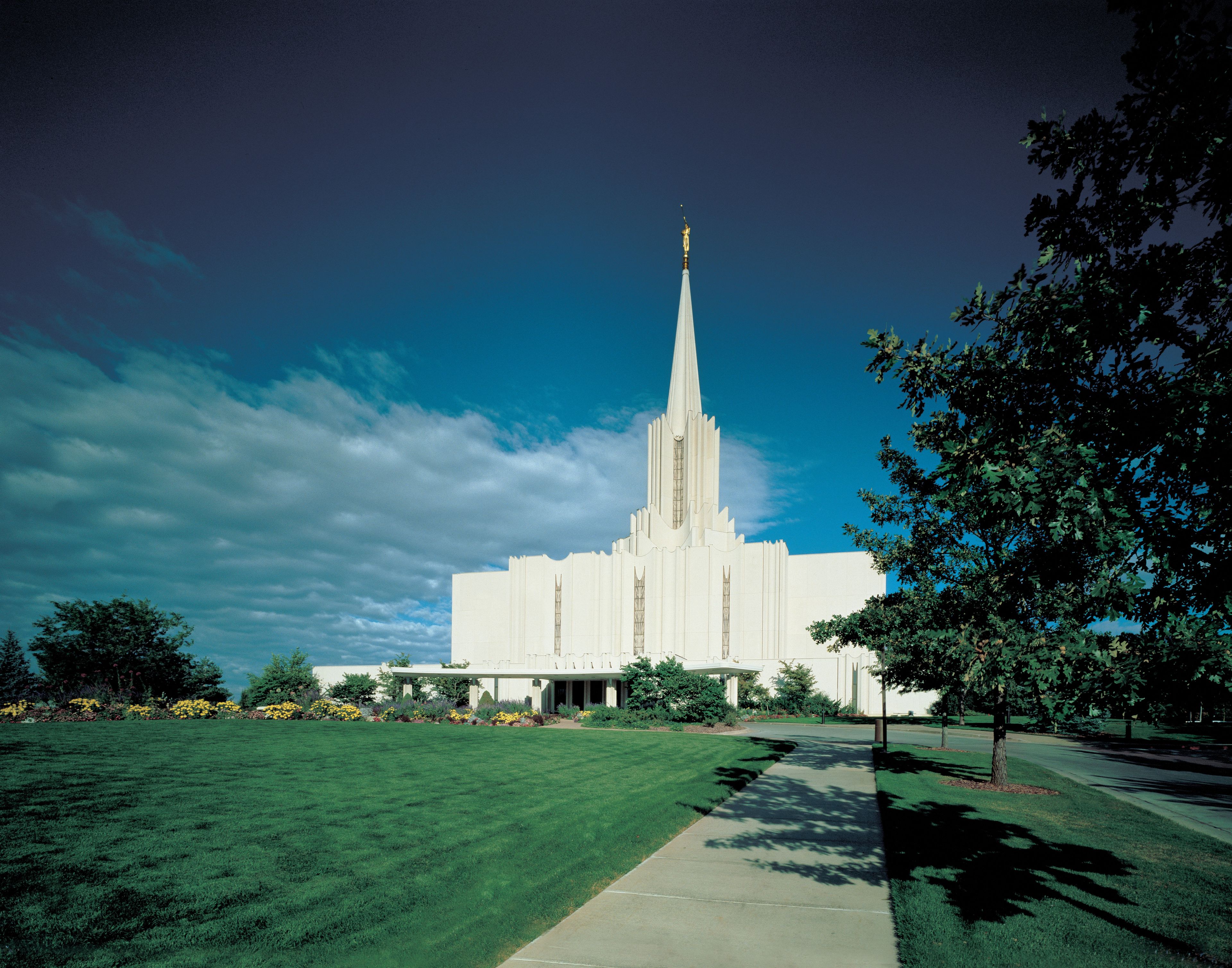 The Jordan River Utah Temple and grounds on a bright day.