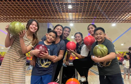 family gathered for bowling