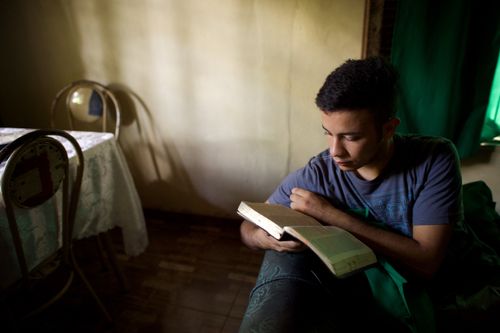 young man reading the scriptures
