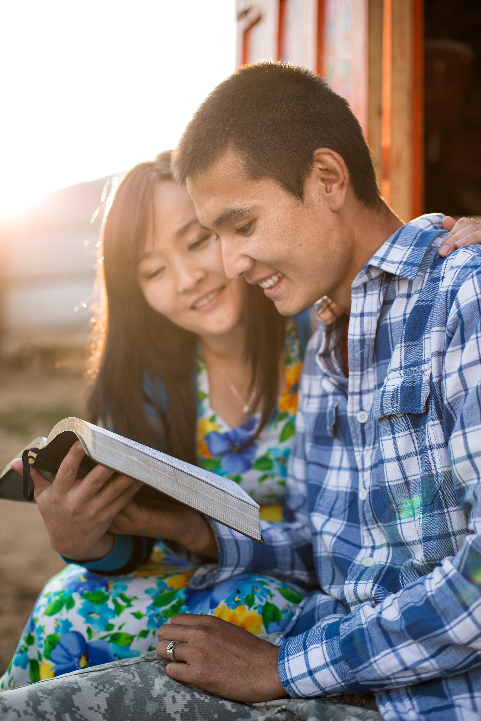 A young couple reading their scriptures together.