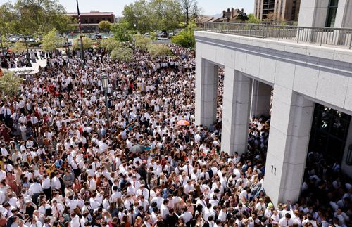 Crowds of young adults flood the Conference Center plaza prior to the start of the worldwide devotional on May 15, 2022.