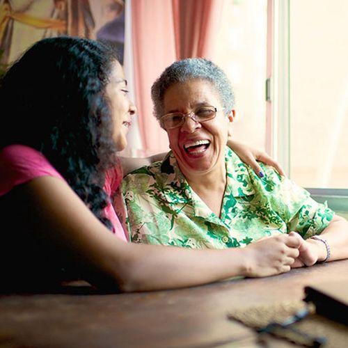 a young woman laughing with her grandmother